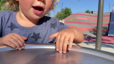 Small-girl-spinning-on-roundabout