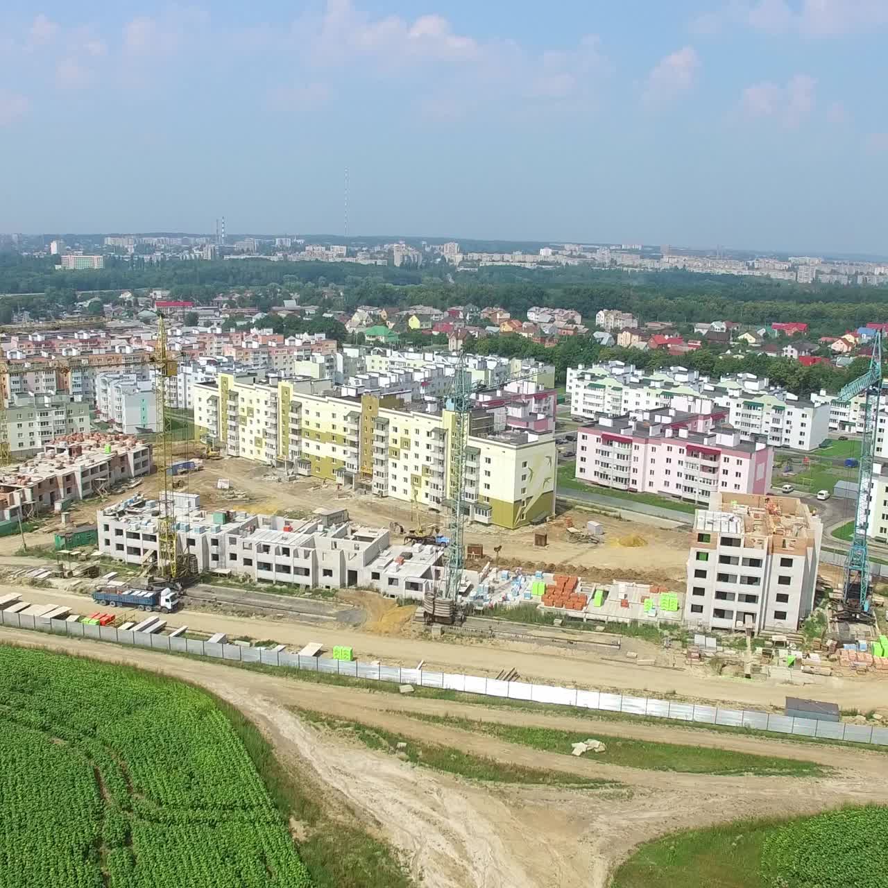 view of the construction of modern high-rise buildings on the background of the panorama of the city. Aerial view