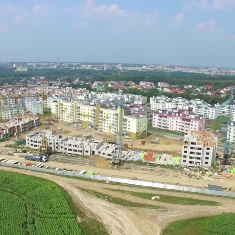 view of the construction of modern high-rise buildings on the background of the panorama of the city. aerial view
