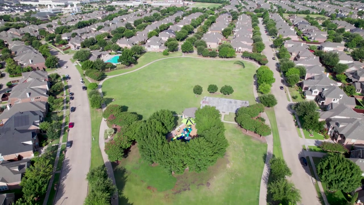 Aerial video of Quail Run Park in Allen, Texas. Camera is moving fast and shows an overview of the park and surrounding houses.