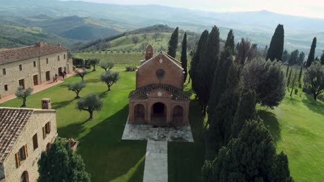 aerial over beautiful italian tuscany village with church and cypress trees