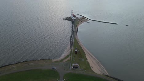 Aerial-at-lake-Markermeer-with-lighthouse-during-spectacular-sunrise