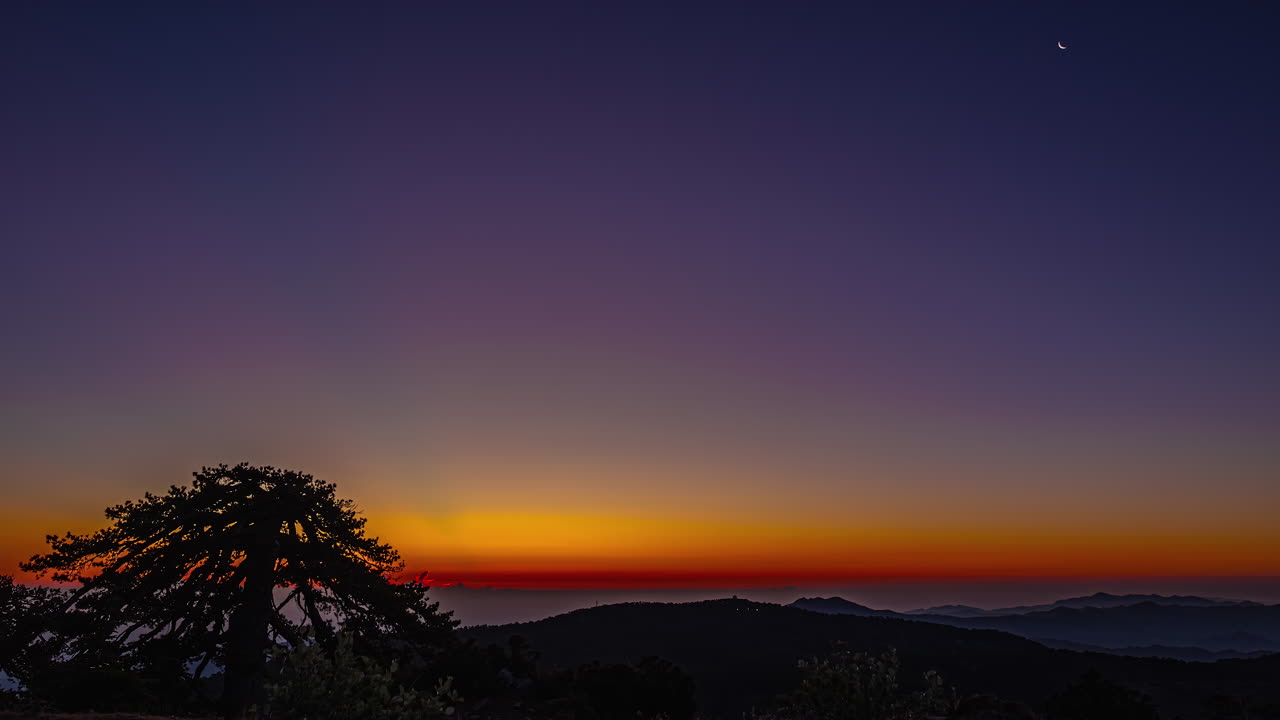 The awe-inspiring allure of Mount Olympus in Cyprus reveals itself during the enchanting sunset, offering a breathtaking landscape distinguished by its warm, reddish glow