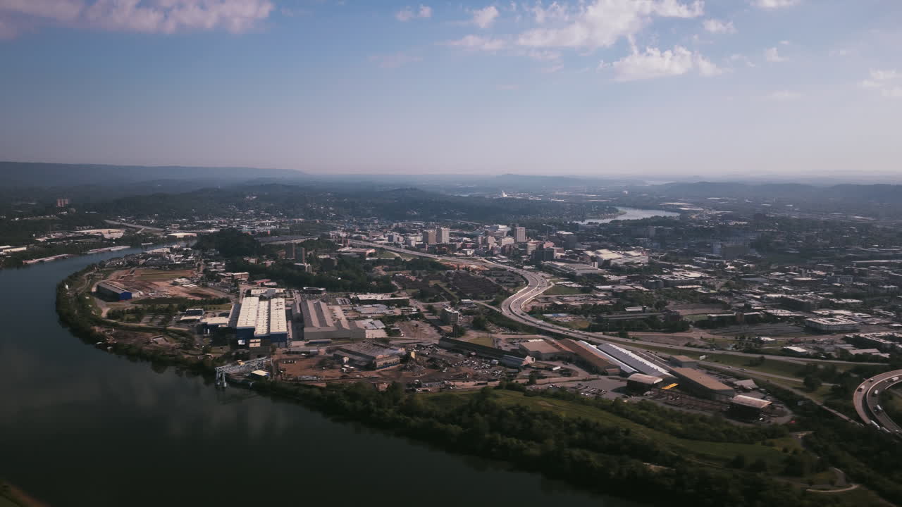 Another aerial view of Chattanooga’s riverfront and downtown, highlighting industrial warehouses and the river’s winding path through the city