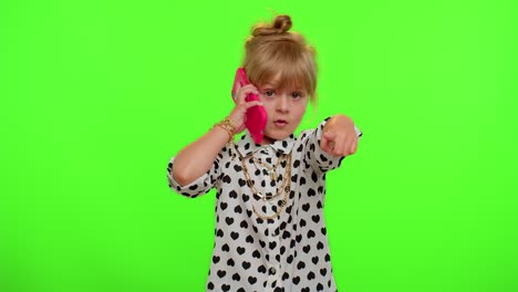 Funny-playful-child-girl-looking-at-camera-doing-phone-gesture-like-says-hey-you-call-me-back