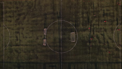 aerial view of a soccer game on a grassy field during daylight