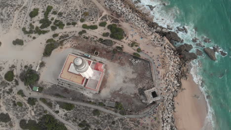 aerial view of cape trafalgar lighthouse at sunset.