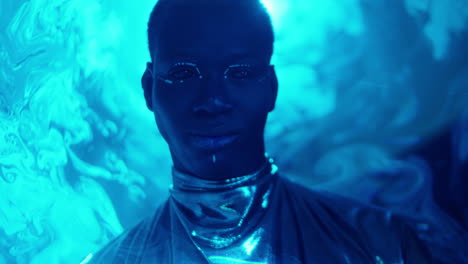 portrait of man with dark eyes and creative makeup in laser light