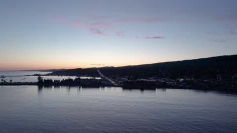 drone aerial view of downtown grand marais, minnesota in the fall at sunset