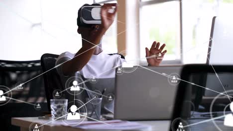 animation of network of connections with icons over african american businessman using vr headset