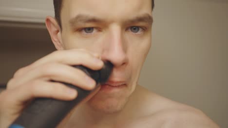 Man-Shaving-Using-Electric-Shaver.-Close-Up