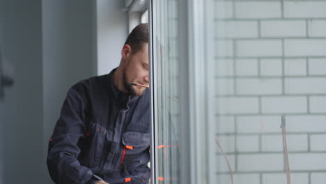 air conditioning wizard. a man at high altitude installs air conditioning. replacement of thermal insulation. air conditioning systems