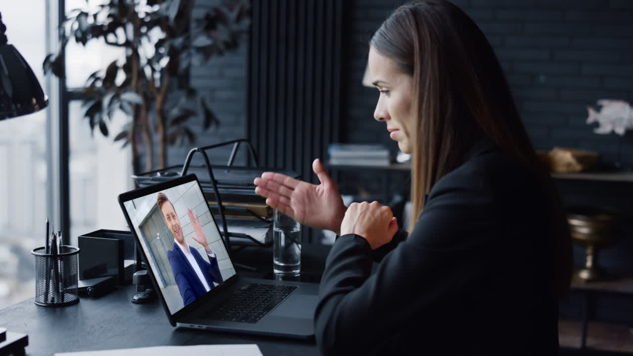 Businesswoman have video meeting by laptop webcam in corporate office closeup