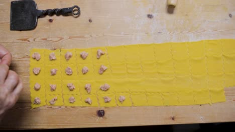 crop women cooking traditional tortellini in kitchen