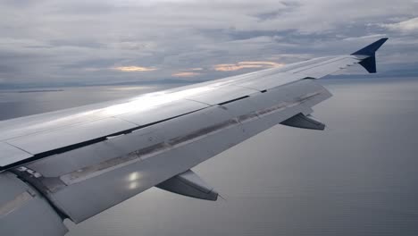 fully extended flaps airplane wing in landing configuration in flight