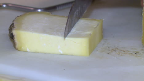 sliced cheese on cutting board