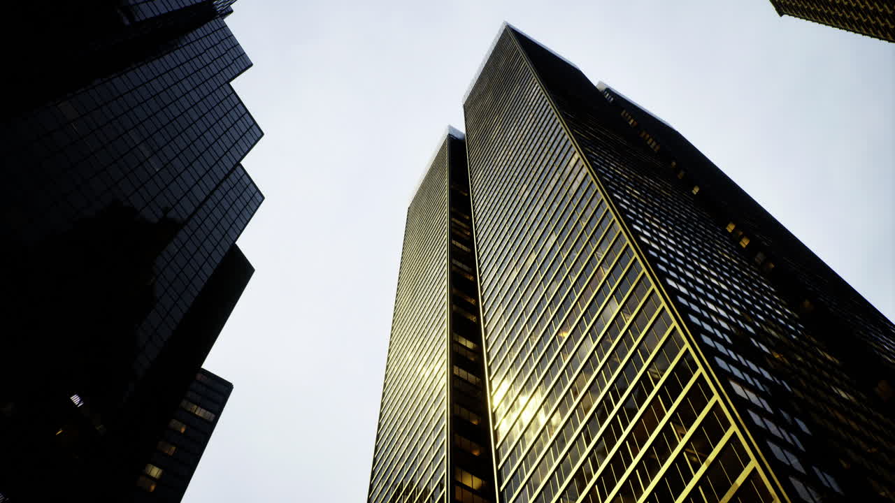 Towering skyscrapers reflect sunlight in an urban environment during daylight