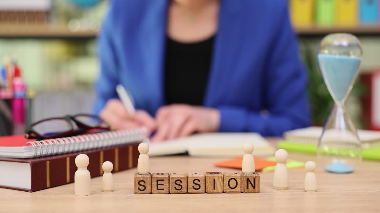 Business Session with Wooden Figures and Hourglass