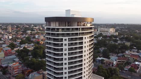 Aerial-drone-footage-of-luxury-high-rise-with-a-view-of-a-large-city