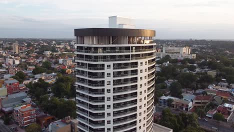 aerial drone footage of luxury high rise with a view of a large city