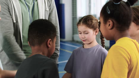 Kids-and-trainer-with-hands-on-the-center