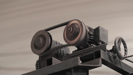 rotating parts with gears of industrial equipment at factory. - close up