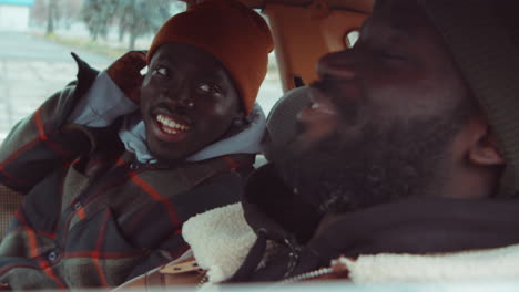 two african american men smiling and chatting in car