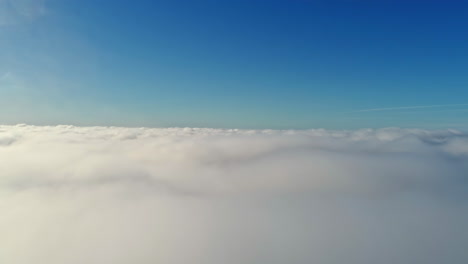 drone view from above from the thick white clouds at sunrise