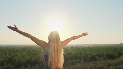 woman stretching outdoors at sunrise/sunset