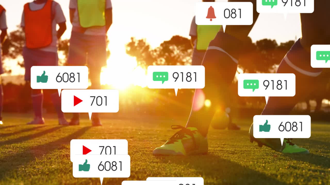 Animation of social media notifications over diverse male football team training on pitch at sunset