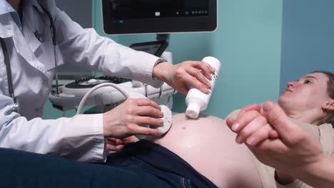 pregnant woman lying on a stretcher in gynecologist consultation