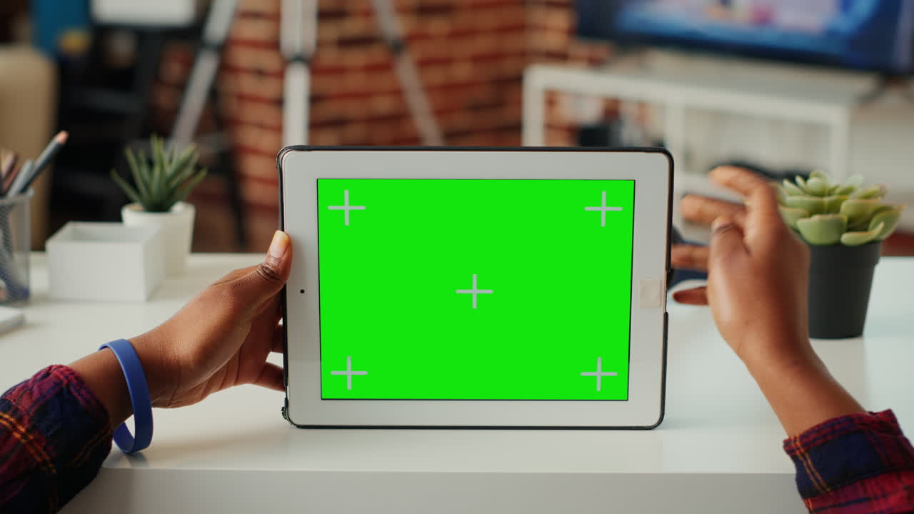 Young entrepreneur using horizontal greenscreen on wireless gadget