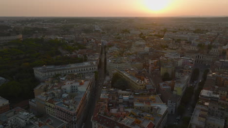 Aerial-panoramic-footage-of-streets-and-buildings-in-Esquilino-borough.-Romantic-view-against-setting-sun.-Rome,-Italy