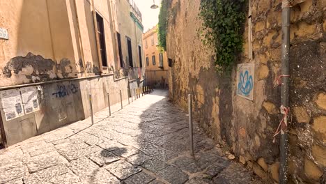 a narrow, sunlit alleyway in naples