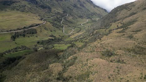 Una-Pequeña-Carretera-Serpenteante-Serpentea-Por-Un-Valle-Estrecho-Con-Curvas-En-Zigzag