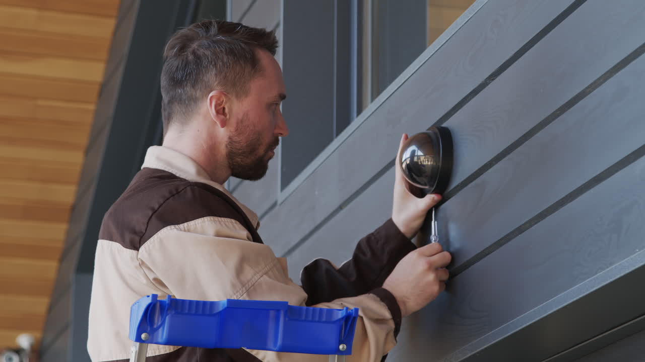 Handyman Installing Security Camera on Clients House