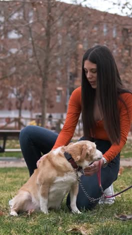 Young woman enjoying a day outdoors in the park with her dog.