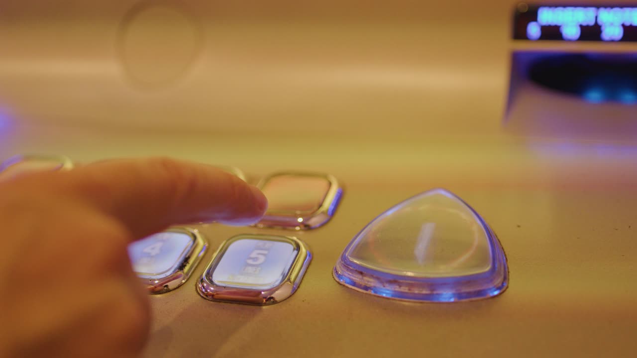 Close-up of illuminated slot machine buttons, finger pressing play, warm ambient casino lighting
