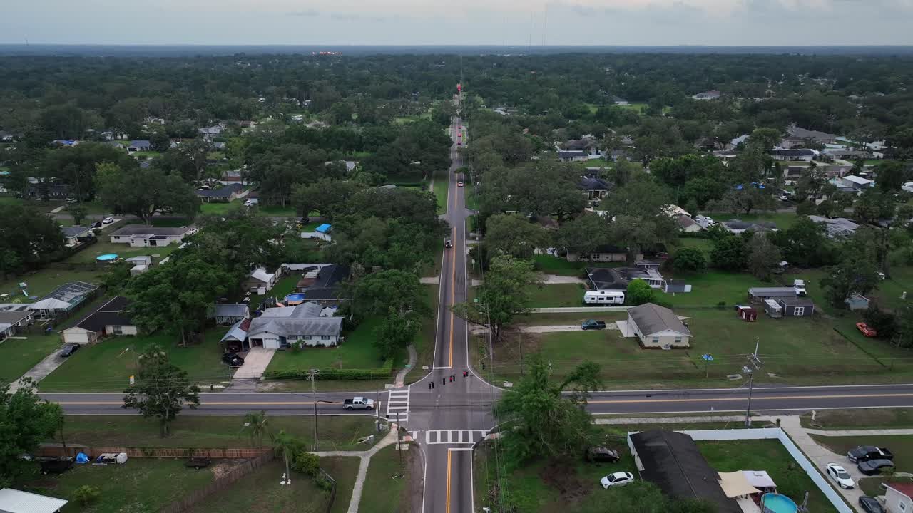 Aerial view of junction of American neighborhood with luxury houses in Florida. Properties in rich district of town. Cloudy day in summer season. Wide shot