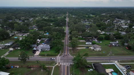 aerial view of junction of american neighborhood with luxury houses in florida. properties in rich district of town. cloudy day in summer season. wide shot