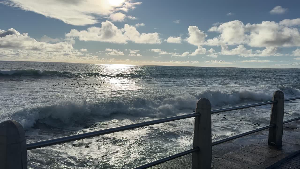 Waves crash on Rocks near Cape Town’s lighthouse on Mouille Point