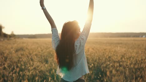 woman enjoying sunset in a wheat field