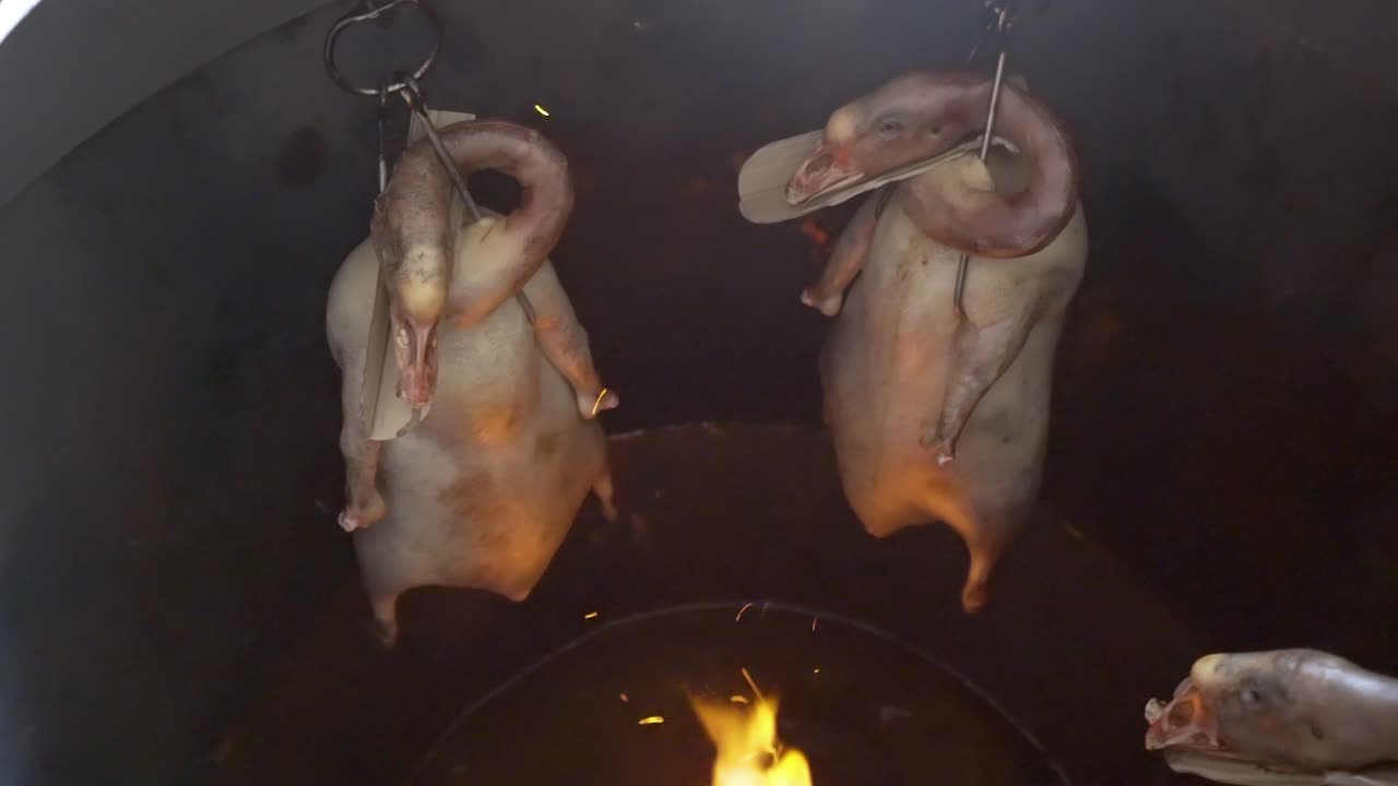 Roasting Whole Geese Over The Fire In A Pit Barrel Cooker In Guangzhou, China - top view
