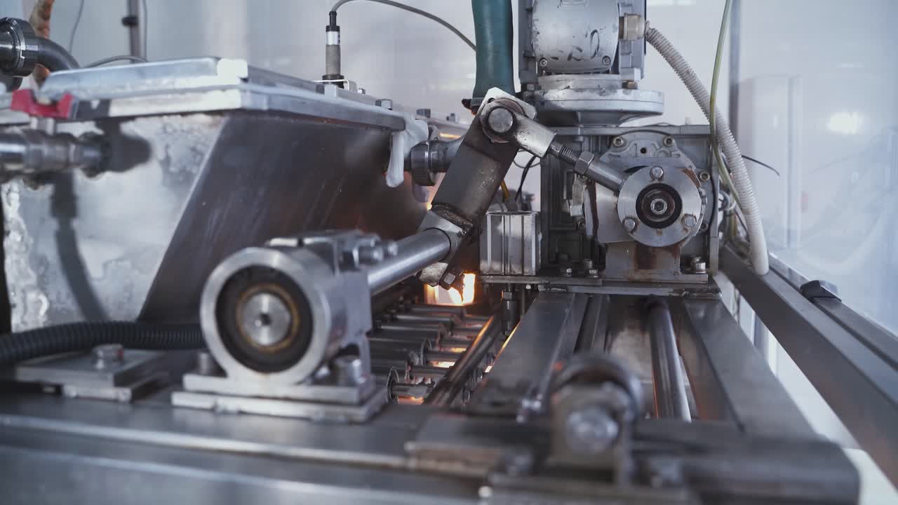 Automatic machine for the production of marshmallows. Rotating shaft and pistons of an automatic conveyor machine in a confectionery factory