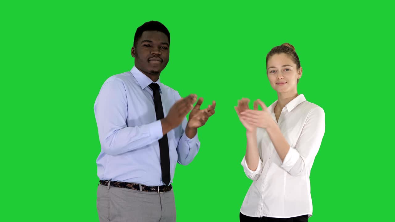 One businessman and one businesswoman applauding on a Green Screen, Chroma Key