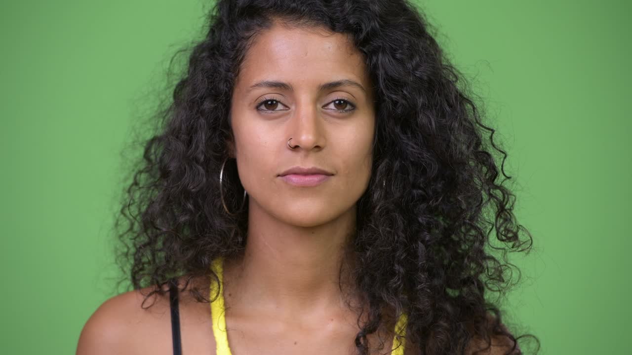 Young beautiful Hispanic woman covering eyes as three wise monkeys concept