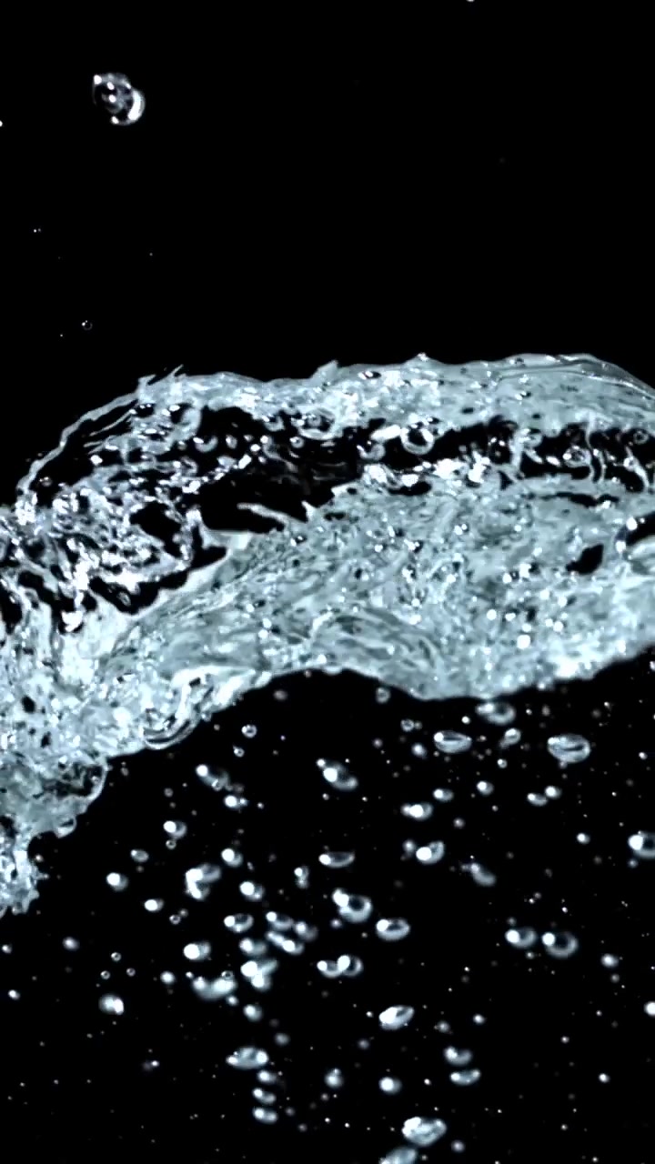 Close-up of Clear Water Splashing and Bubbling on Black Background