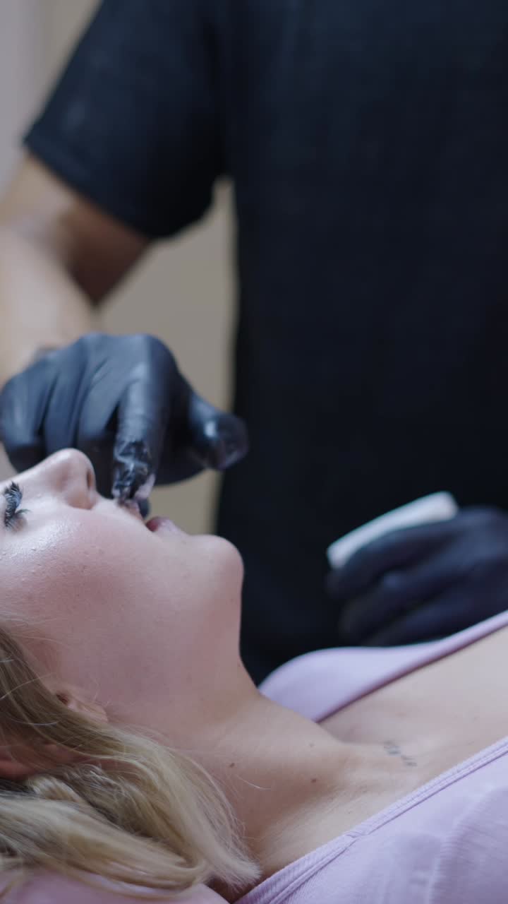 Woman receiving lip treatment