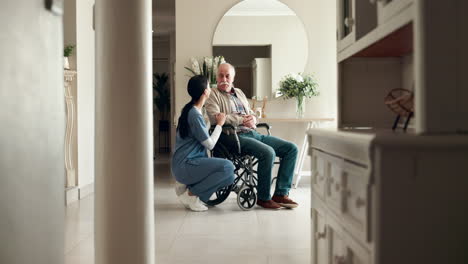elderly man in wheelchair with nurse at home