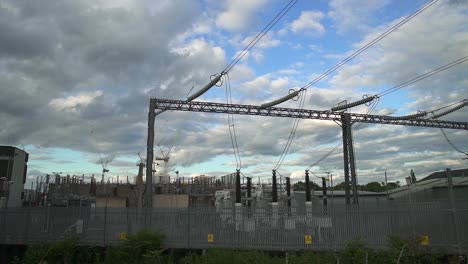 pan right on a power station with power lines and electricity cables